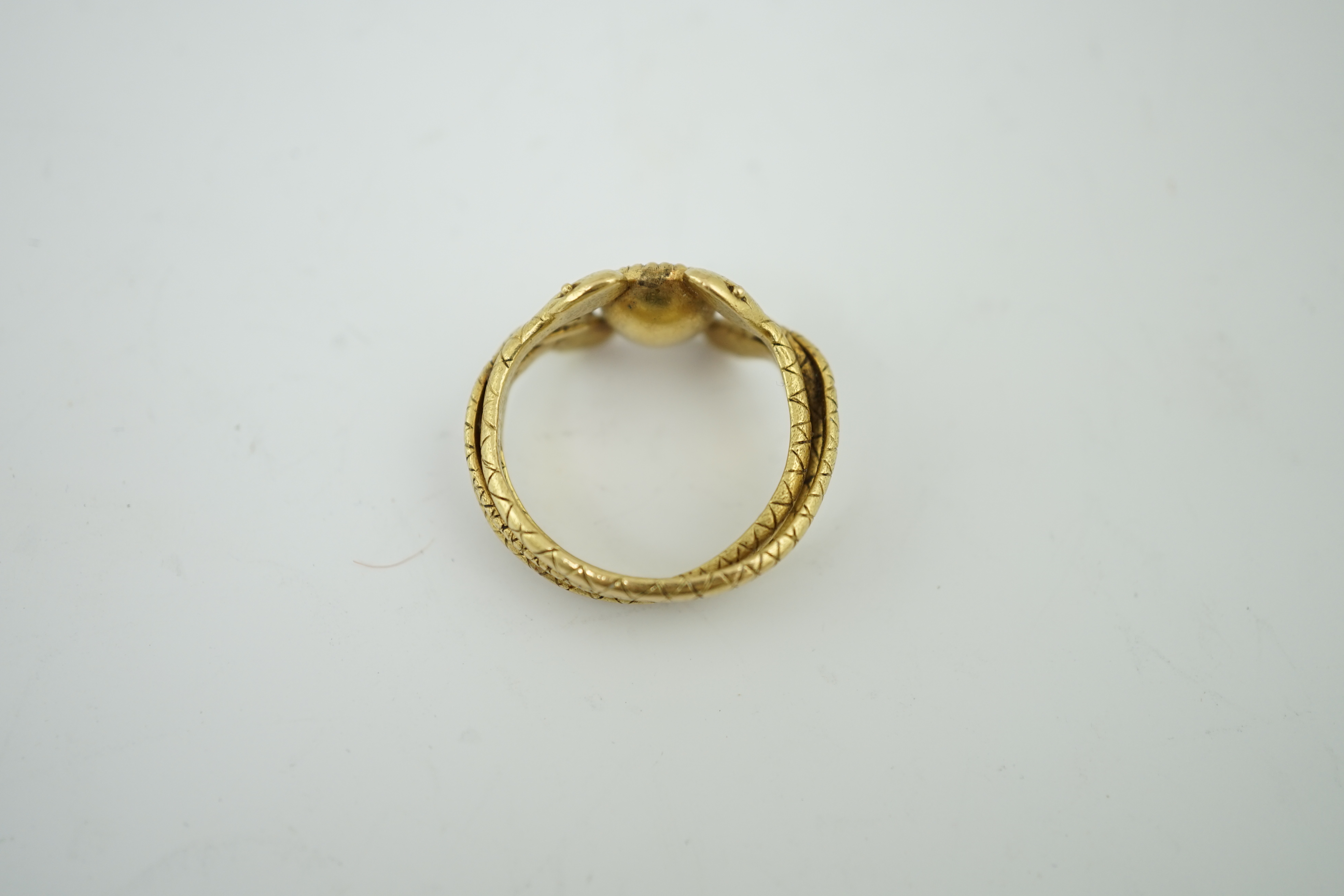 A late 19th century American Marcus & Co gold and single stone oval cut Sri Lankan sapphire set serpent ring